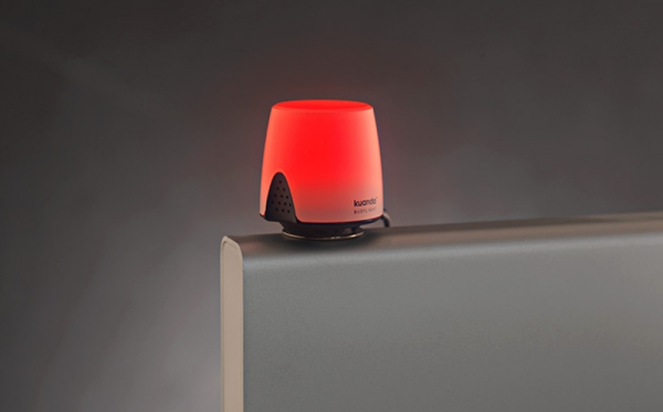 Kuando Busylight UC Omega showing a red busy light while attached to an office monitor.